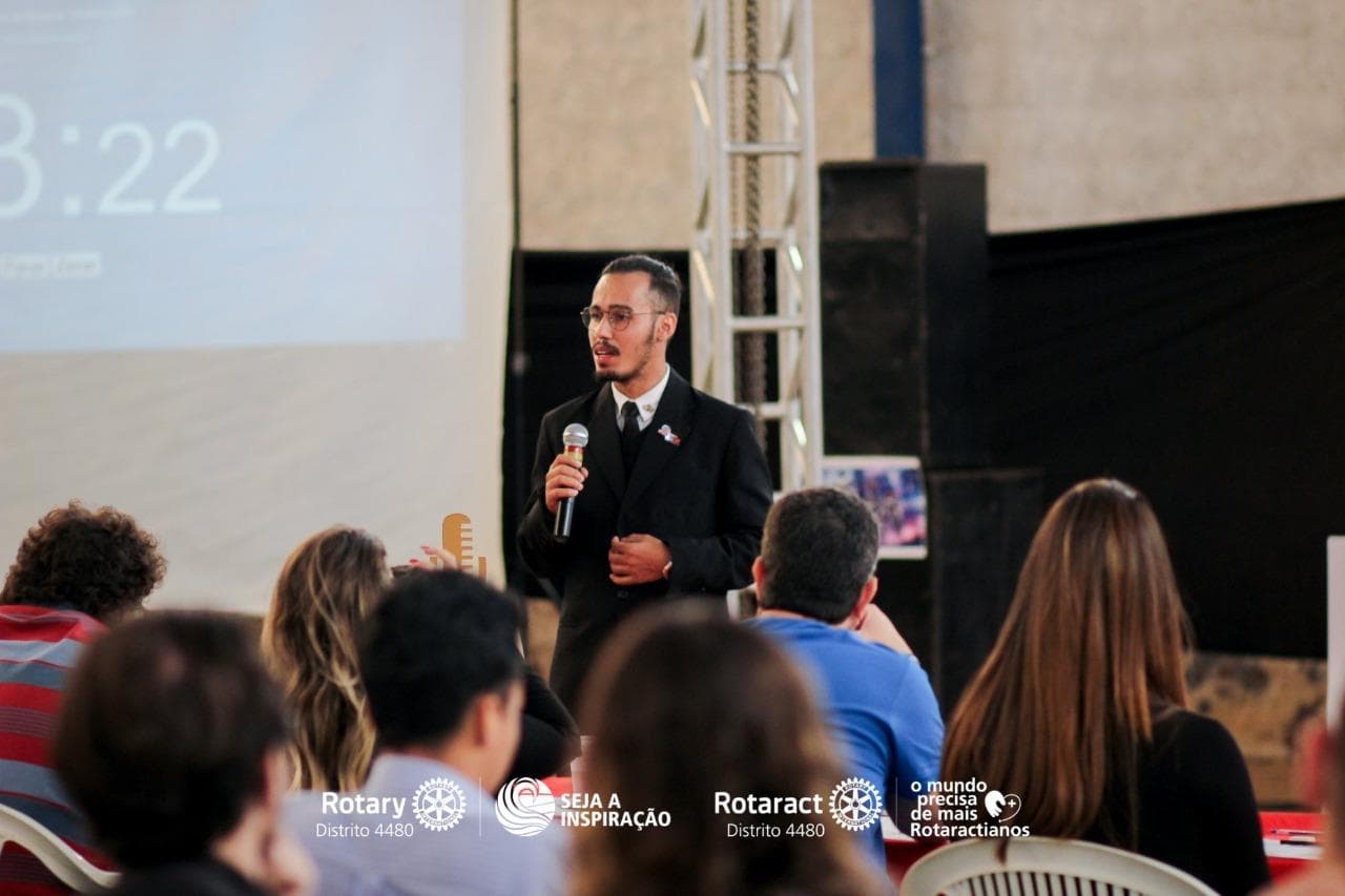 Man speaking on stage at Rotary conference